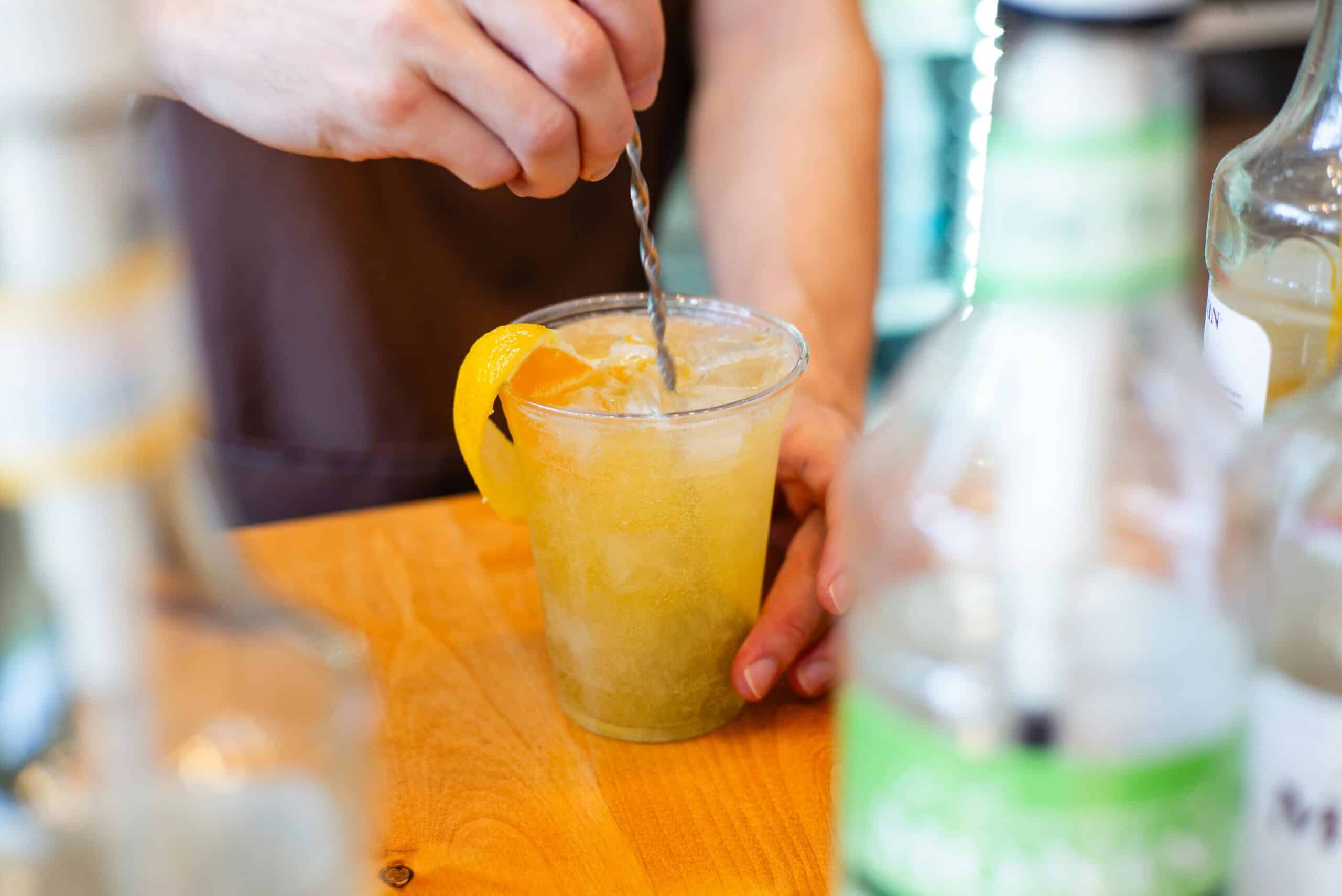 agua de valencia an alcoholic orange drink being stirred on a bar